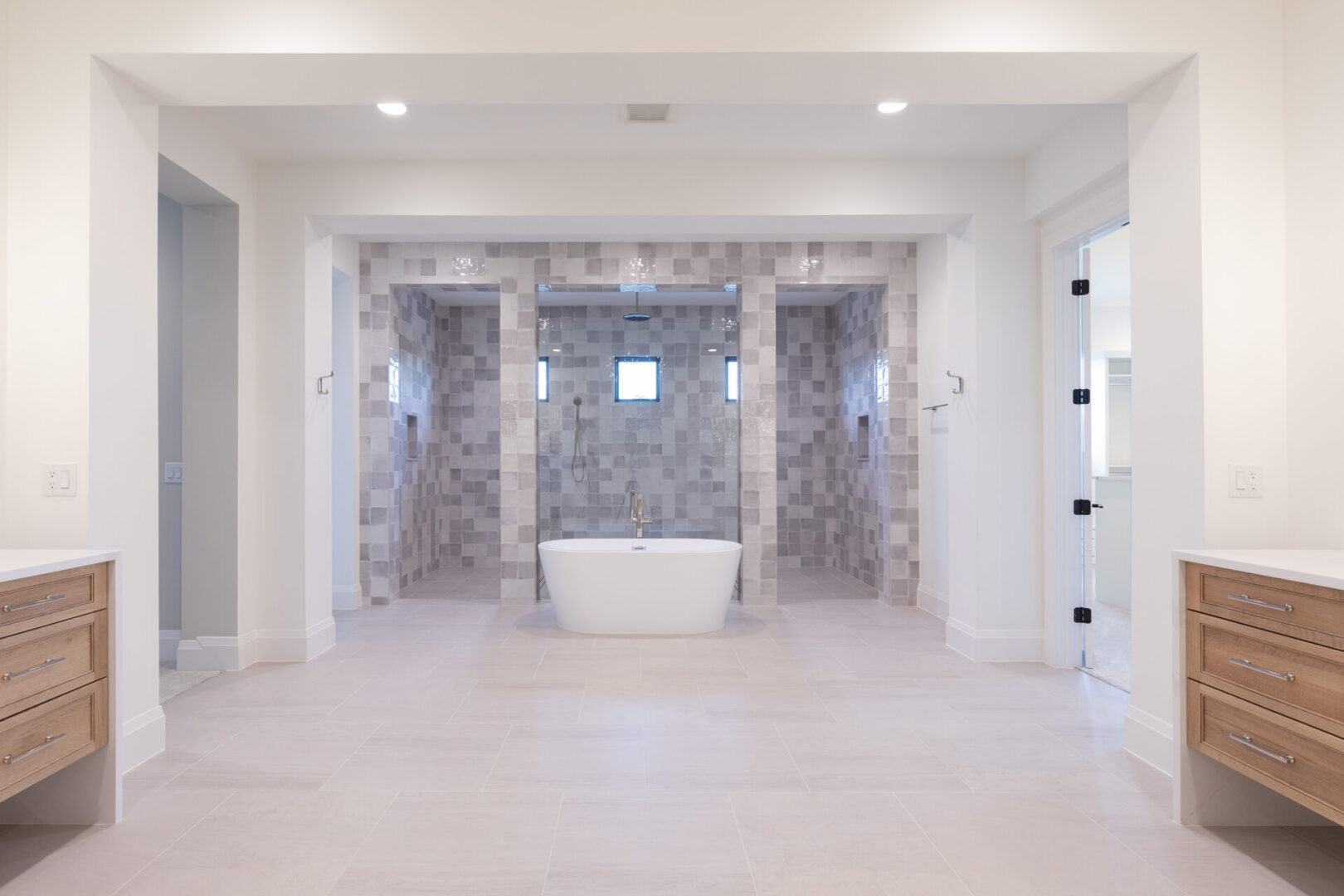 A bathroom with two large walk in shower stalls.